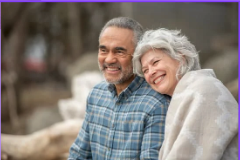 Older couple sitting together outdoors